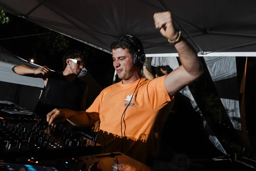 DJ aux platines, poing levé, pendant la closing du Belfield Festival 2026